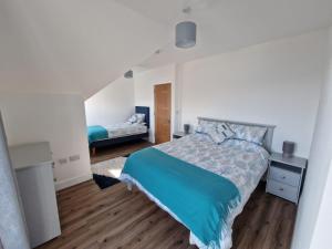 a bedroom with a bed with a blue blanket at Beachview Rental in Clare Island