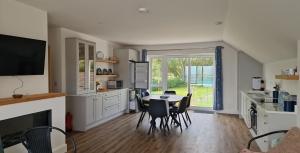 a kitchen and dining room with a table and chairs at Beachview Rental in Clare Island
