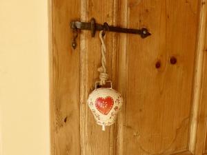 a heart shaped tag hanging on a wooden door at Basel Landskron Haus in Leymen +17 photos