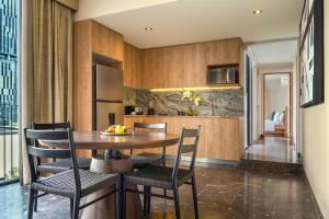 a kitchen and dining room with a table and chairs at NH Guadalajara Studios in Guadalajara
