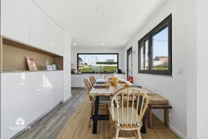 a kitchen and dining room with a table and chairs at Mara Etxea - Villa with pool e Ocean View in Ericeira +45 photos