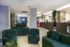 a lobby with couches and chairs in a store at Hotel Palmas Executivo in Balneário Camboriú +42 photos