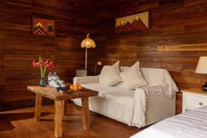 a living room with a bed and a table with flowers at Maia House Homestay in Sóc Sơn +21 photos