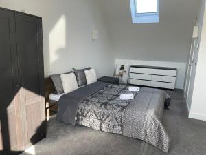 a bedroom with a bed and a couch in it at Waverley 3-Bed Springfields House in Rotherham