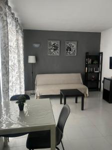 a bedroom with a bed and a table and chairs at Aguazul 120 in Tías
