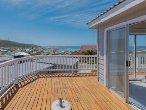 a large deck with a view of the ocean at Poolstreet 18 in Agulhas