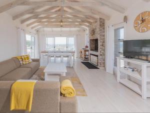 a living room with a couch and a table at Poolstreet 18 in Agulhas