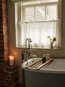 a bathroom with a sink and a window at The Black Horse in Amberley