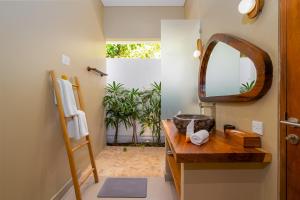 a bathroom with a wooden sink and a mirror at Villa Canopy - Spacious Luxury 4BR Villa Near Nuanu and Luna Beach Club in Tabanan