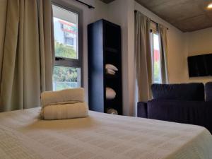 a bedroom with a bed with a chair and a window at Espectacular departamento en Palermo in Buenos Aires