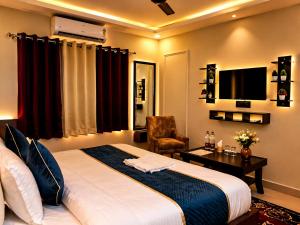 a hotel room with a bed and a chair at Pavitram Hotel & Banquet in Rānchī