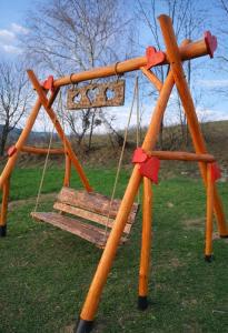 a wooden swing set with a sign on it at Kuca za odmor in Vitez