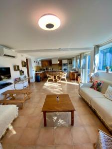 a living room with a couch and a table at Appart 70m2 avec piscine in Saint-Geniès-de-Varensal