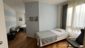 a small bedroom with a bed and a couch at Bombyx Inn in Bergamo