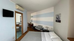 a bedroom with a bed with a striped wall at Bombyx Inn in Bergamo