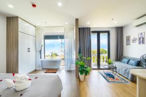 a hotel room with a tub and a bedroom at La Cheminee Boutique Apartment in Phú Quốc