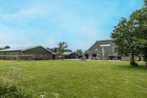 a field with a soccer goal in front of a building at Duintentje in Schiermonnikoog