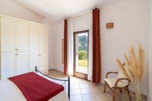 a bedroom with a bed and a large window at Porto Cervo-Villa La Gjanda in Abbiadori +29 photos