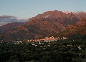 a town in the middle of a mountain range at L'Hostal de Piaghja in Calenzana