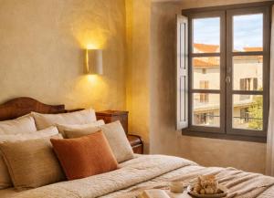 a bedroom with a bed and a window at L'Hostal de Piaghja in Calenzana