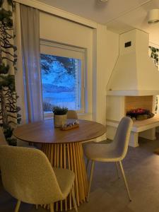a kitchen with a table and chairs and a window at Meri-Karina in Turku