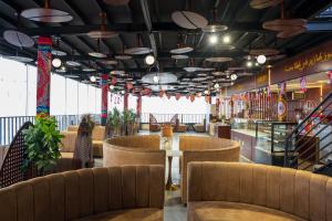 a restaurant with brown chairs and a table in the middle at فندق جولدن بلكون-Golden Balcony Hotel in Abha