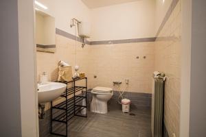 a bathroom with a white toilet and a sink at Casa Peppina in Gubbio +23 photos