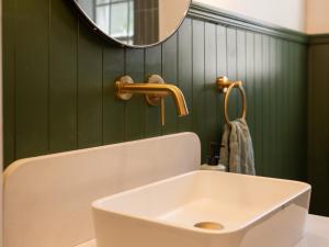 a bathroom with a white sink and a mirror at House Erens By Die Bos in Stellenbosch +18 photos