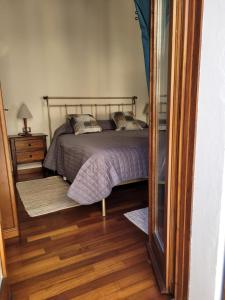 a bedroom with a bed and a wooden floor at Ca' Irene in Stresa
