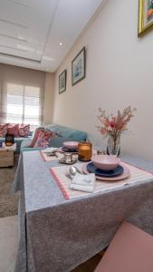 a living room with a table with dishes on it at Cosy appartement in Bouznika