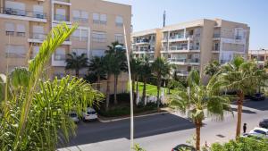 an apartment complex with palm trees and buildings at Cosy appartement in Bouznika