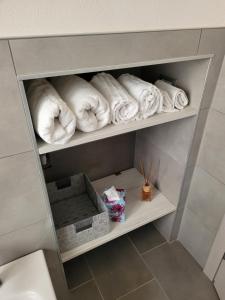 a towel rack with rolled towels in a bathroom at Ca' Irene in Stresa +29 photos