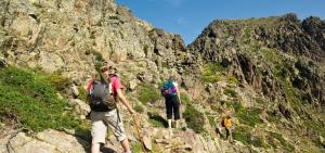 a group of people walking up a rocky mountain at Villa Sant Antone in Ghisonaccia