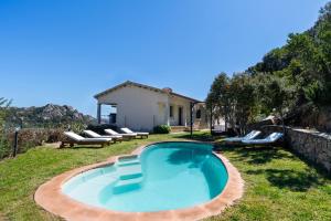a swimming pool in the backyard of a house at Porto Cervo-Villa La Gjanda in Abbiadori