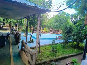 a resort with a pool in the background at Kilibase Hotel in Moshi