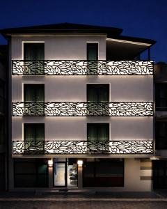 a white building with a balcony at night at Vip Stay in Gotse Delchev