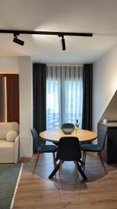 a living room with a table and chairs and a couch at Vip Stay in Gotse Delchev +15 photos