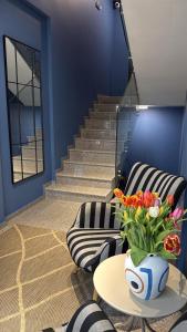 a room with a couch and a table with a vase of flowers at Vip Stay in Gotse Delchev