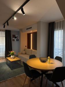 a living room with a table and a couch at Vip Stay in Gotse Delchev