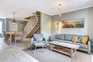 a living room with a couch and a table at FeHa Windspiel in Loddin