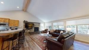 a living room with a couch and a fireplace at 1 Fifteenth Tee Lane in Sunriver