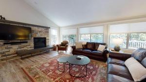 a living room with a couch and a fireplace at 1 Fifteenth Tee Lane in Sunriver