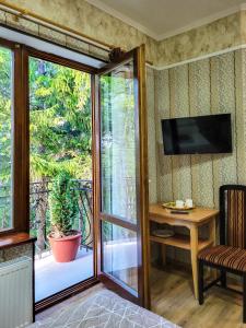a room with a sliding glass door leading to a patio at Glory Apart Hotel in Truskavets