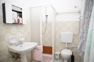 a bathroom with a sink and a toilet and a shower at Alta Marea in Fossacesia