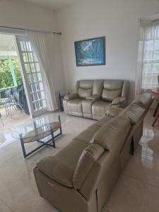 a living room with a large couch and a table at Villa Nirvana II in Mount Irvine