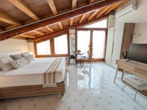 a bedroom with a large bed and a table at Al Castello B&B in Eboli