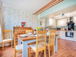 a kitchen and dining room with a table and chairs at 4 Bed in Wigton oc-sz384 in Bothel