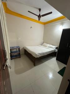 a bedroom with a bed and a ceiling at Vinayak guest house in Mandrem