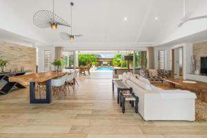 a living room with a white couch and a table at Clos du Littoral by Sealodge Mauritius in Grand-Baie