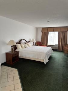 a hotel room with a bed and a window at Garrison Inn and Suites in Garrison +45 photos